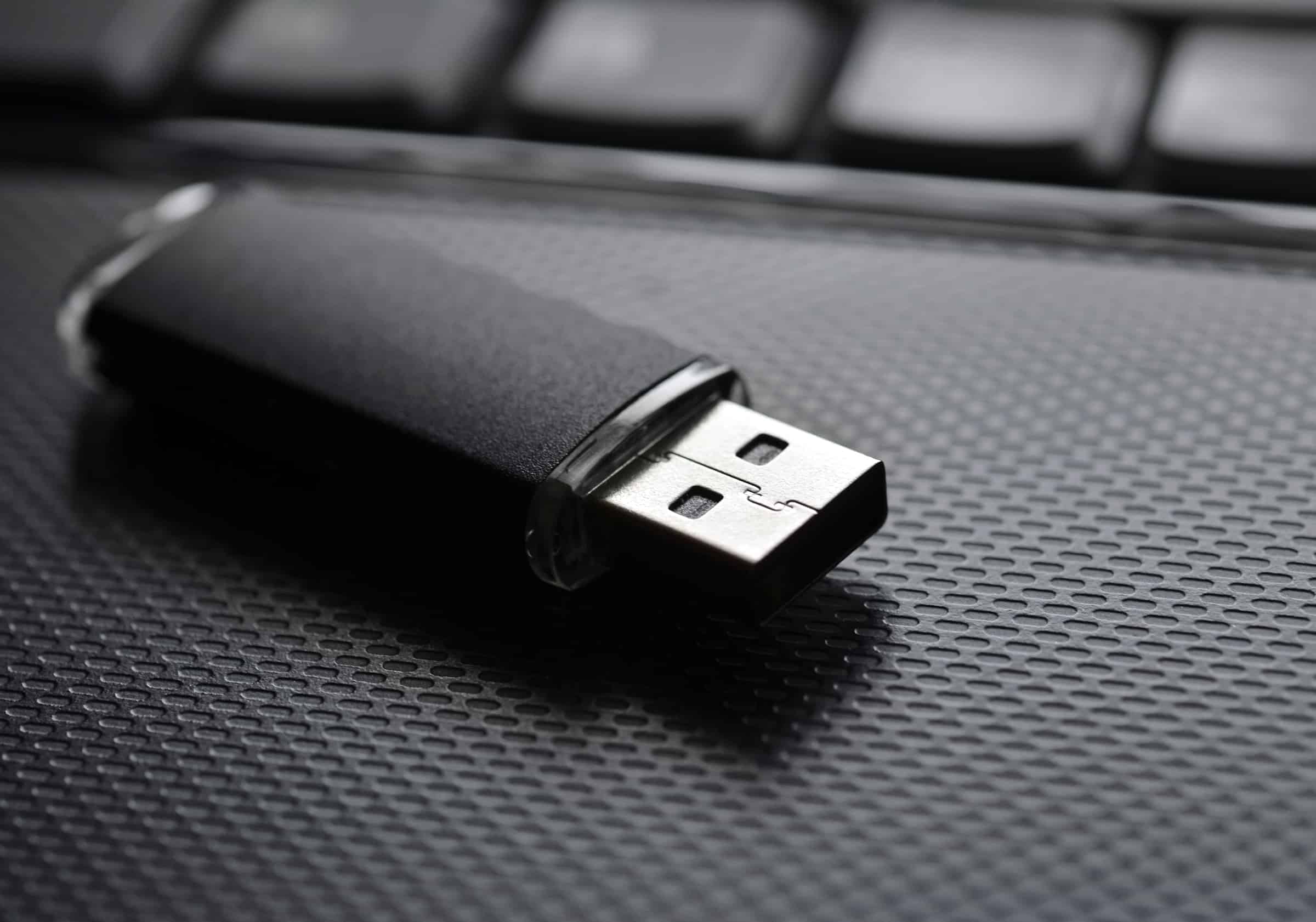 black usb flash drive on a laptop computer