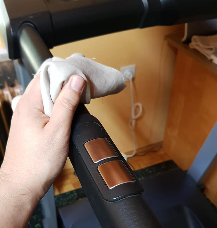 Wiping clean the treadmill handrails
