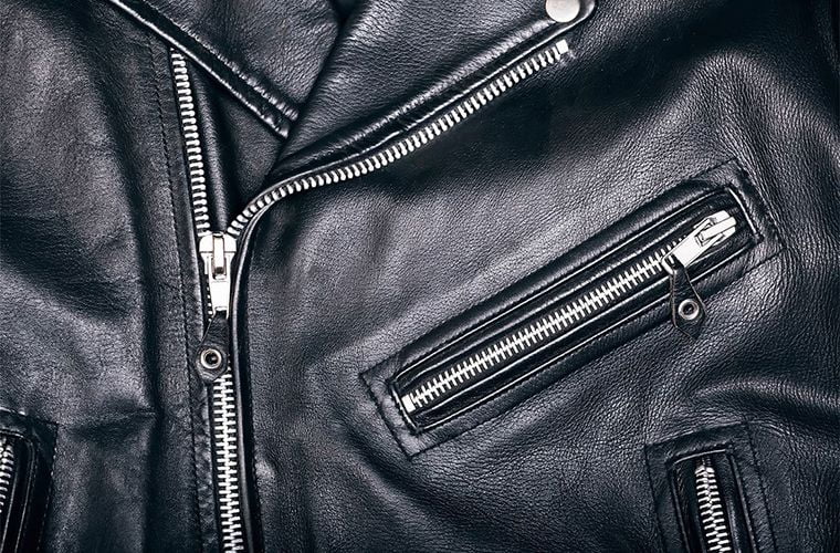 close up of a black leather jacket with zippers