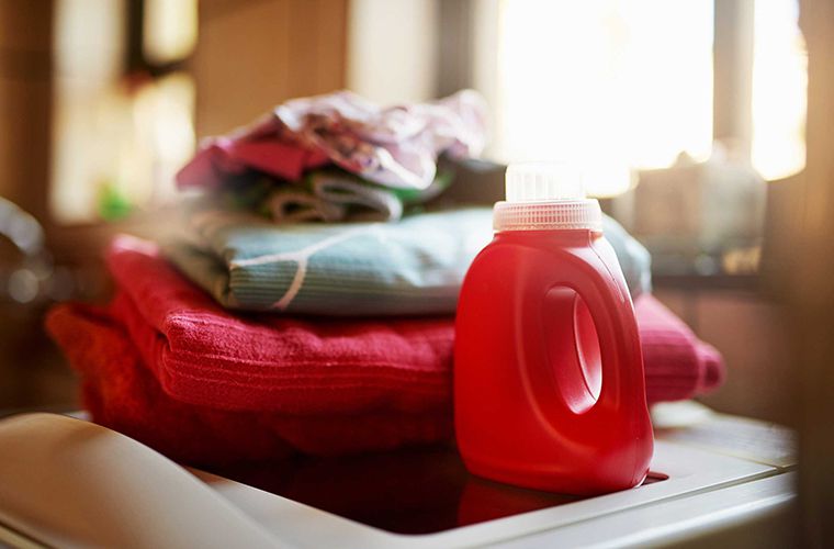 laundry detergent with laundry in the background