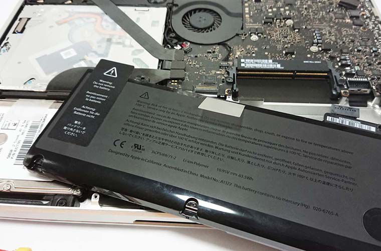 macbook with a removed cover and battery