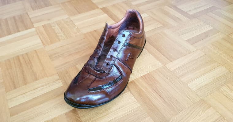 unlaced brown leather shoe