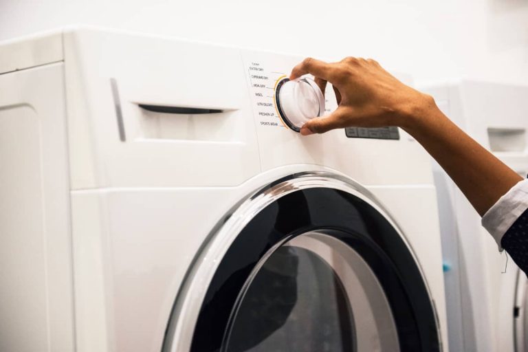a woman setting up the washing machine