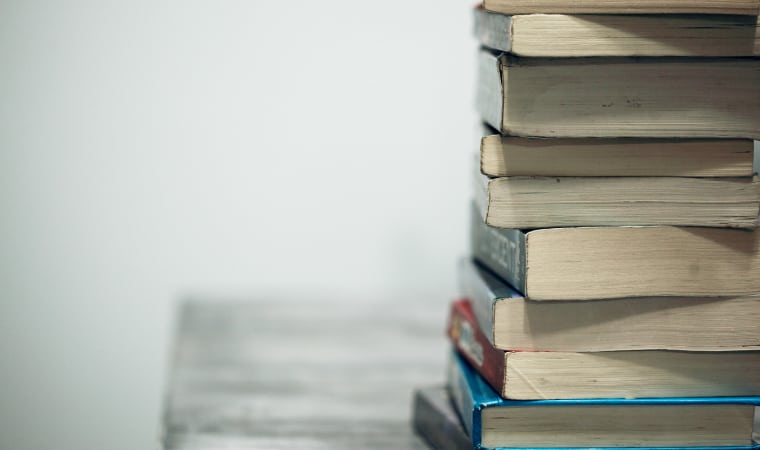 assorted books on a wooden table