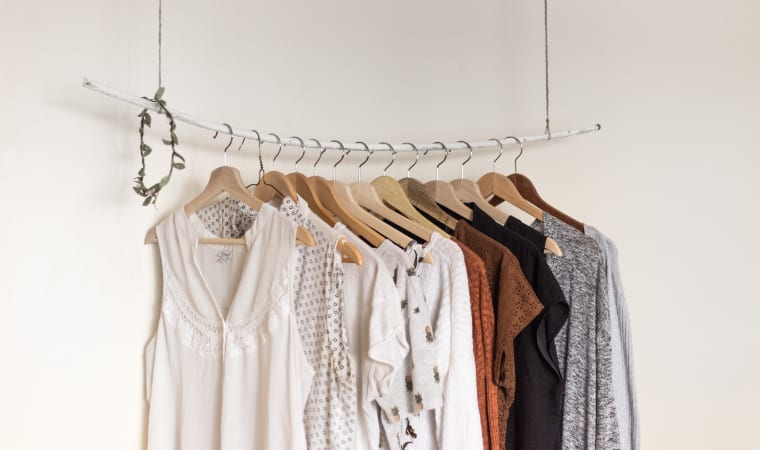 assorted clothes on wooden hangers