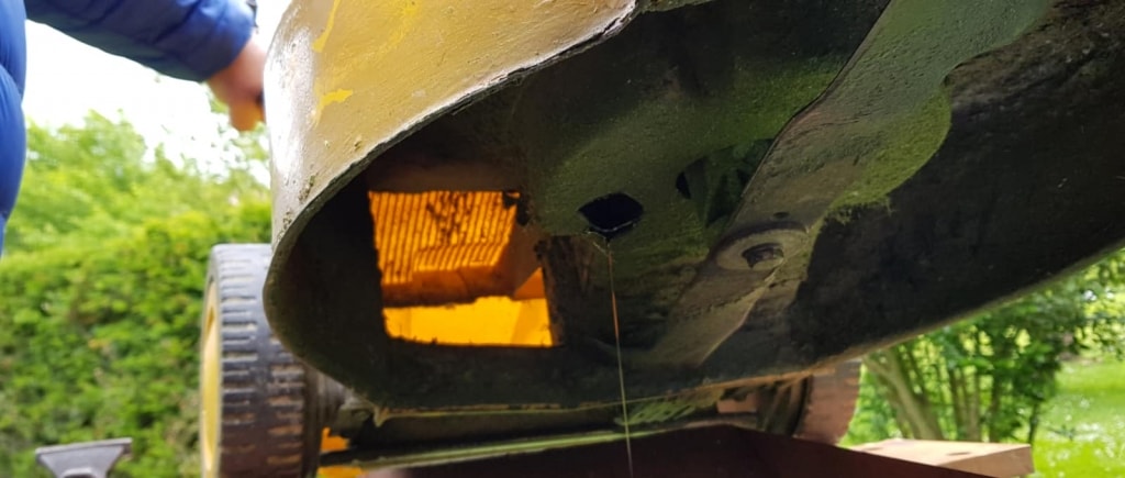 draining oil on a lawn mower