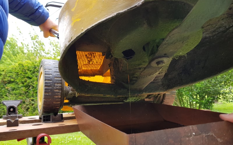 draining oil on a lawn mower 2