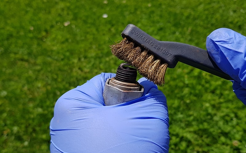 spark plug cleaning with a wire brush