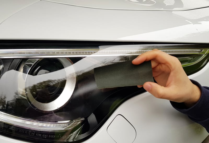 cleaning headlights with a sandpaper