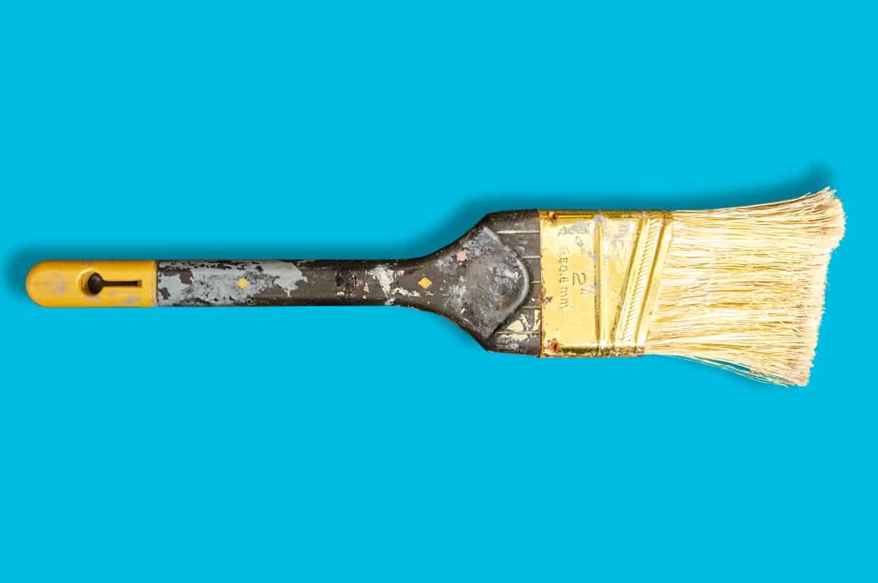 dirty paint brush on blue background