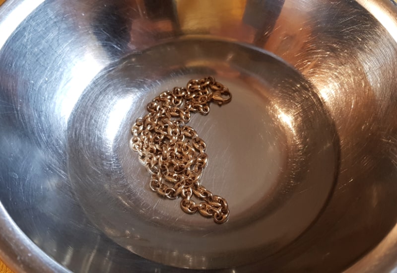 gold chain soaking in water