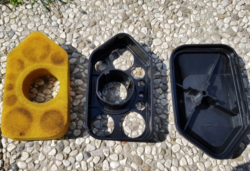 disassembled lawn mower air filter