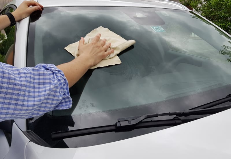 drying up the windshield with a cloth