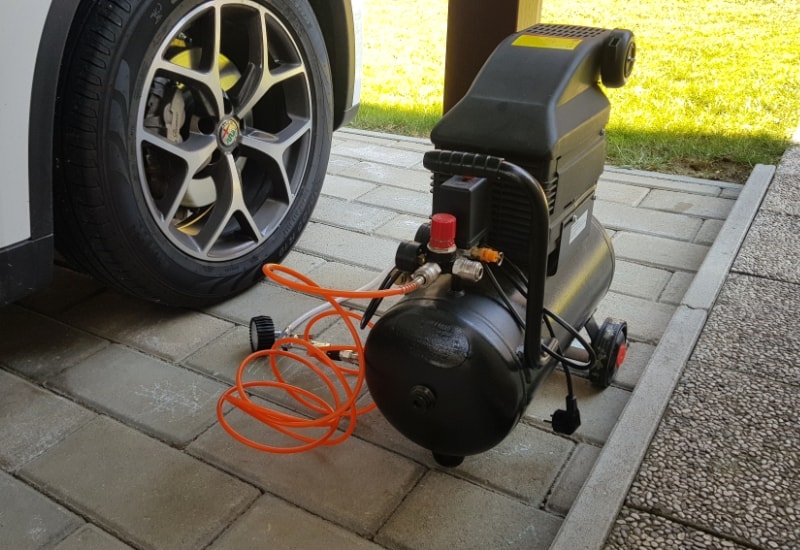 air compressor next to a car