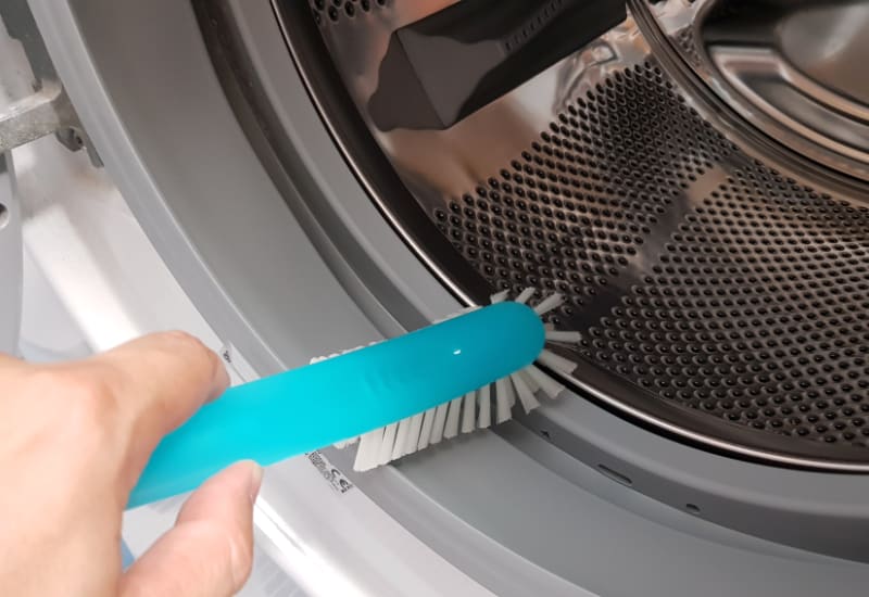 scrubing the door sealant on washer