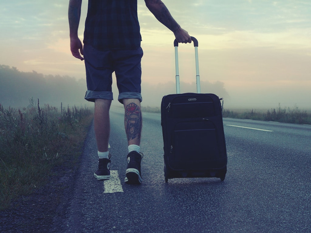 Man pulling soft side suitcase